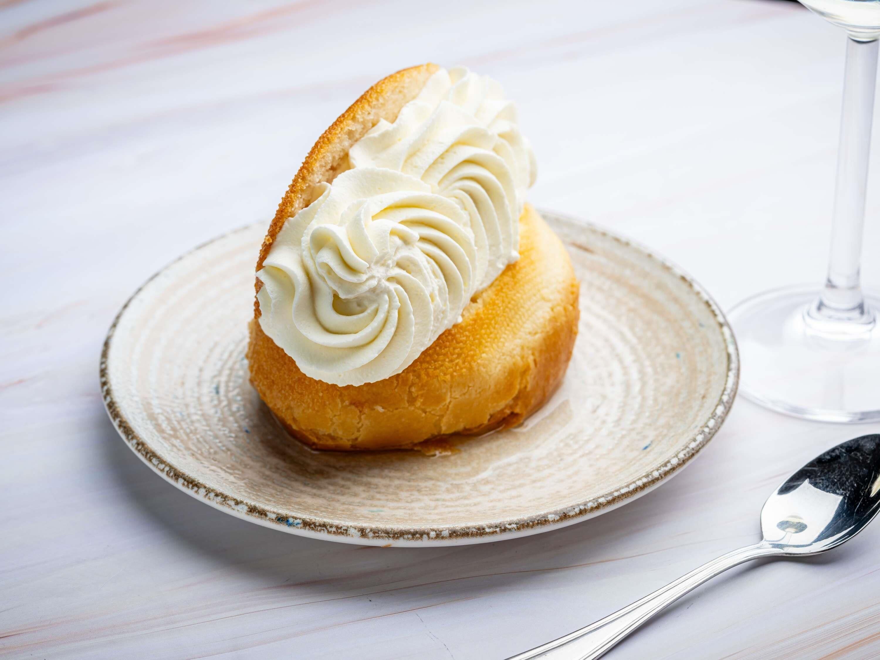 A dessert on a plate with a spoon beside it.
