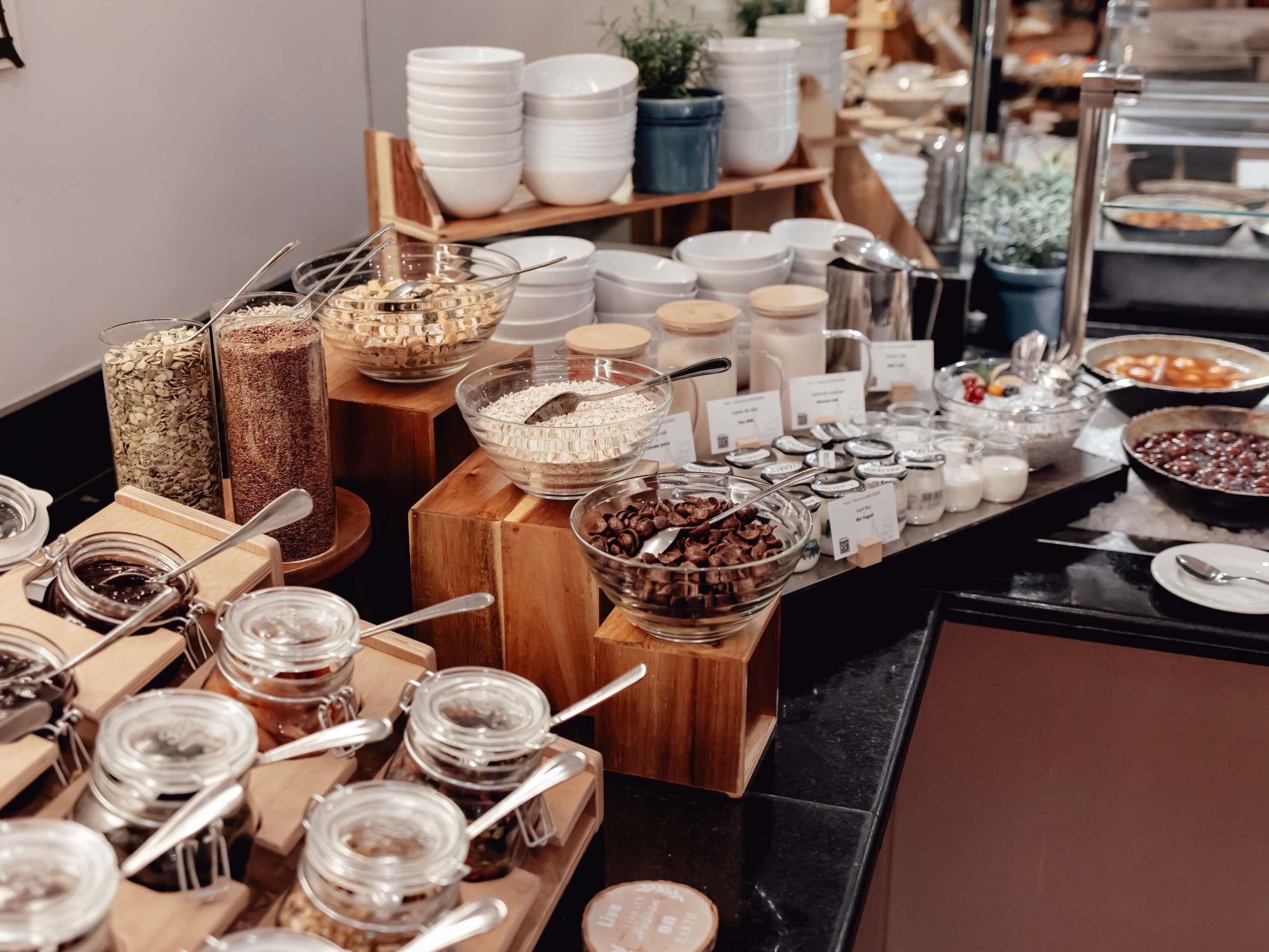 A buffet with various food items and condiments.