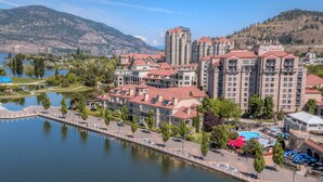 A hotel with multiple buildings, a swimming pool, and a waterfront view.