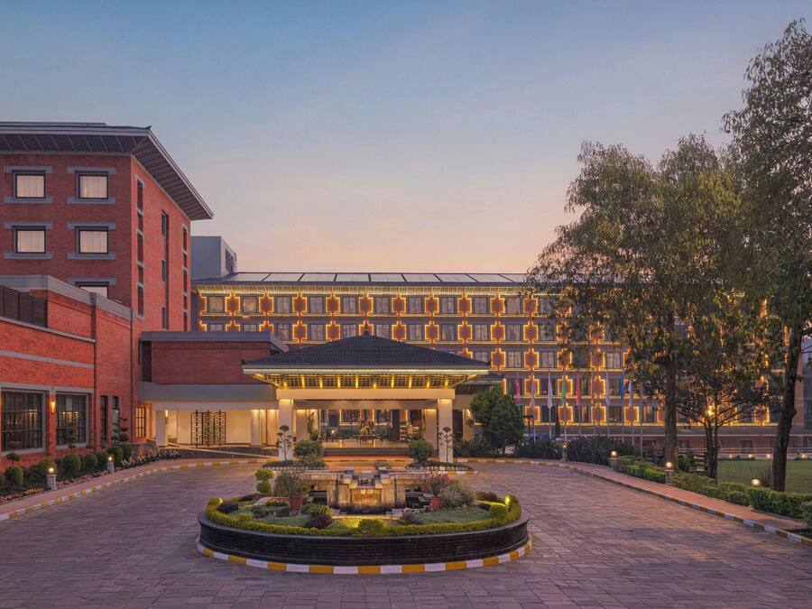 A hotel with a central courtyard, a brick facade, and a modern design.