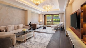 A spacious living room with a sofa, coffee table, and TV.