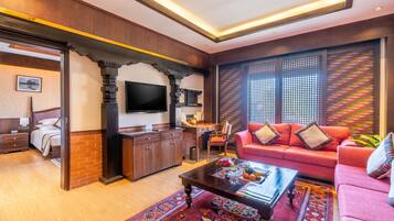 A modern living room with a sofa, coffee table, and TV.