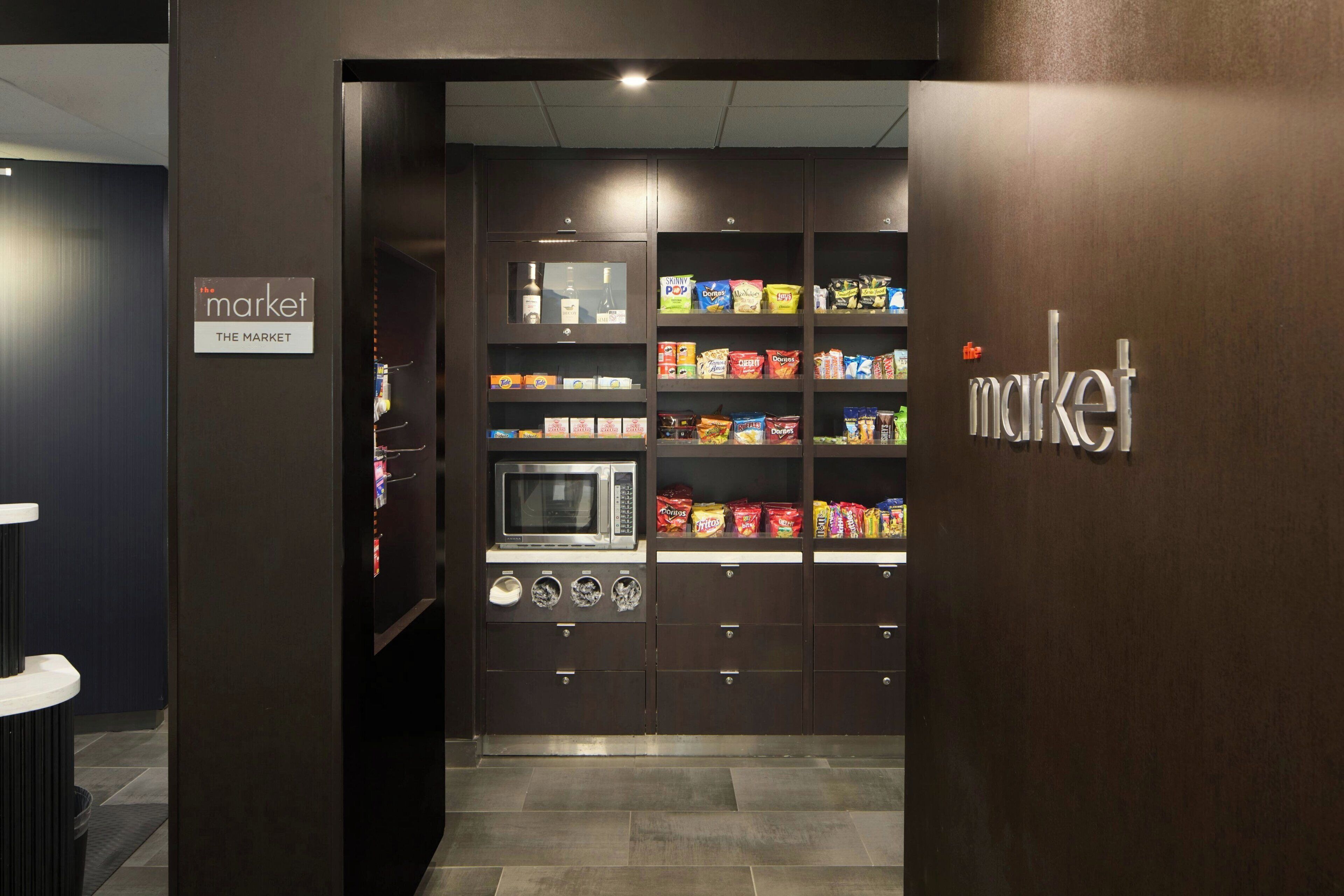 A vending machine area with snacks and a microwave.