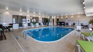 An indoor swimming pool with clear lane markings, surrounded by seating areas and a reception desk. - Comfort Inn & Suites Waterloo - Cedar Falls (Waterloo)