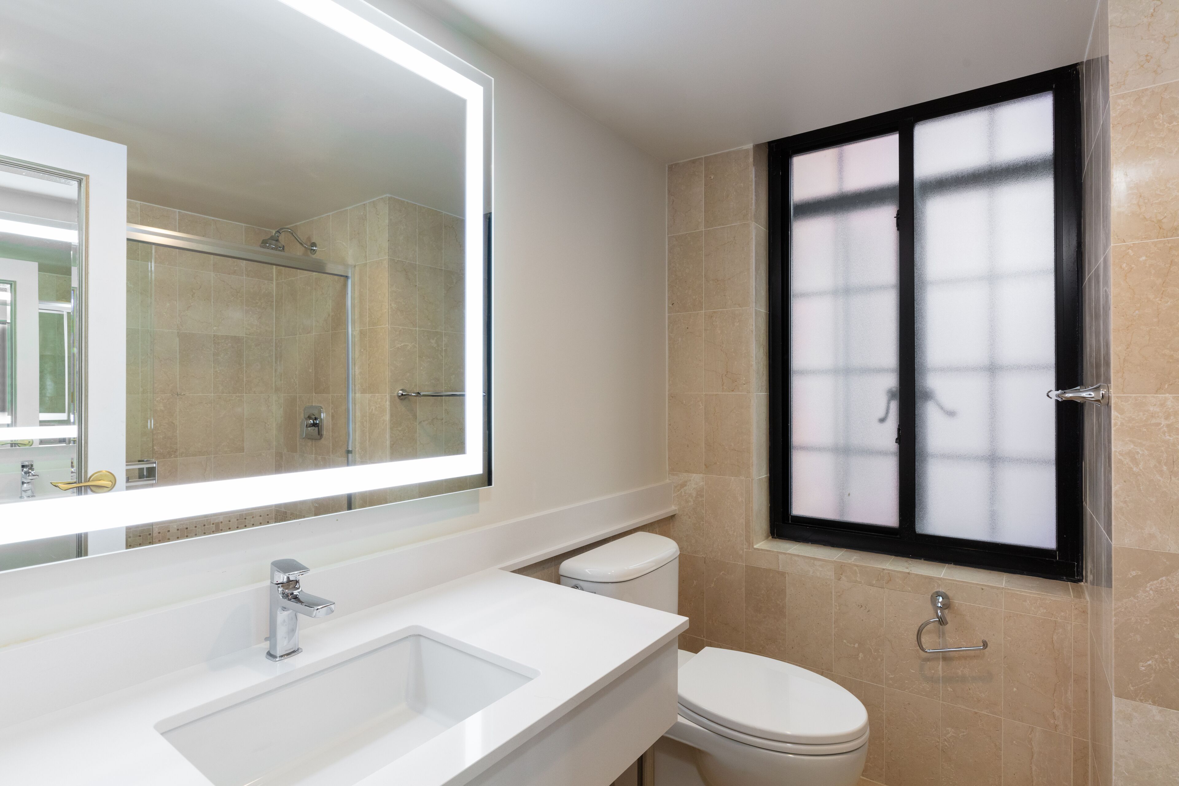 luxe two queen beds | bathroom | combined shower/bathtub, designer toiletries, hair dryer, towels