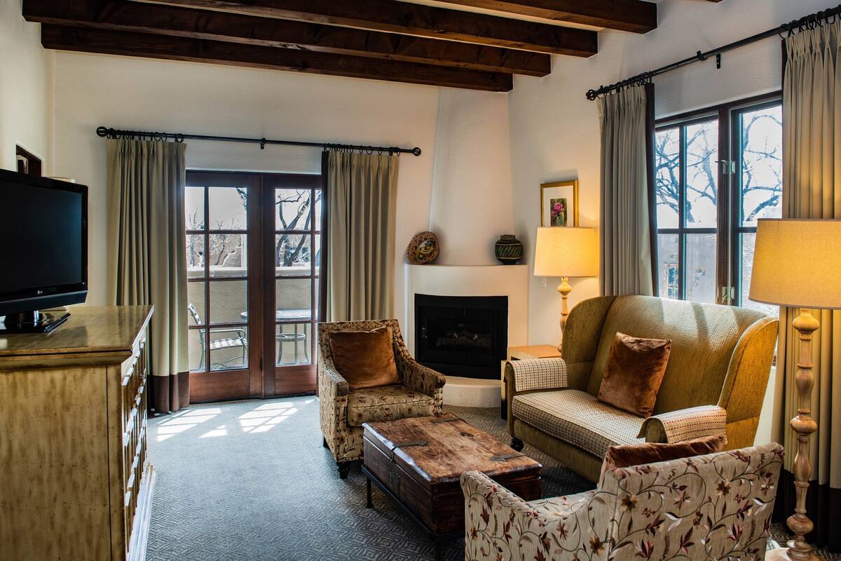 A cozy living room with a fireplace, a television, and comfortable seating.
