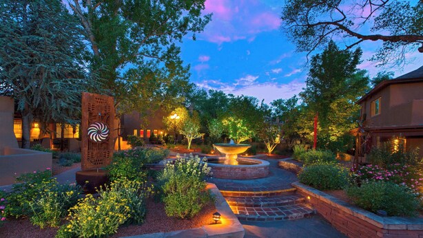 A landscaped garden with a central fountain, surrounded by brick pathways and various plants. - La Posada de Santa Fe, A Tribute Portfolio Resort & Spa by Marriott (Santa Fe)