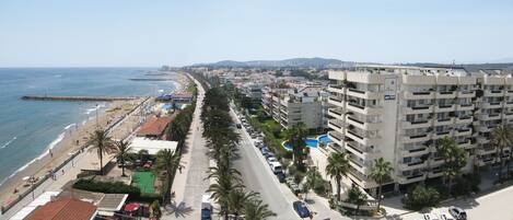 A coastal hotel with multiple floors, a beachside location, and a swimming pool.