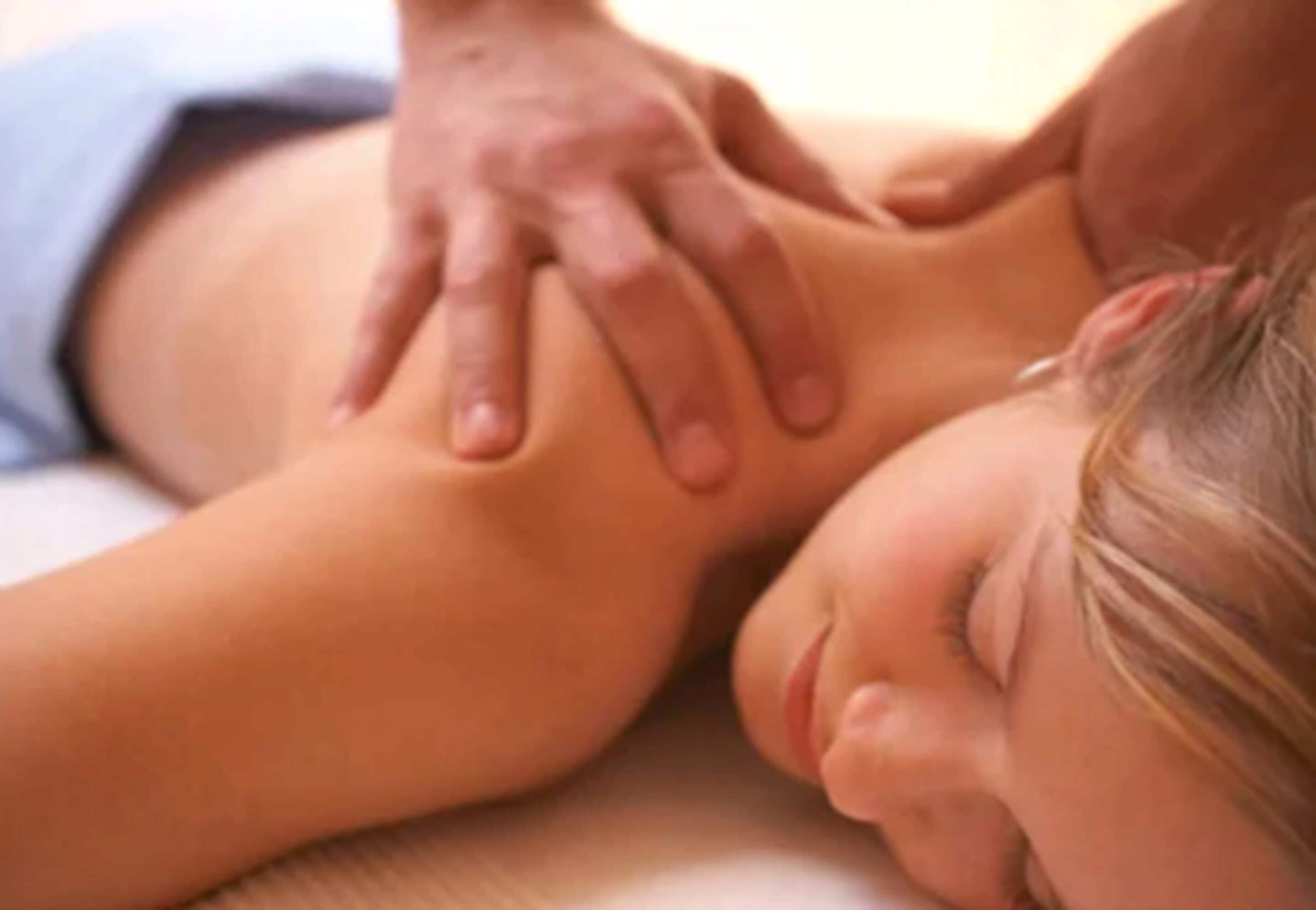A person receiving a massage on a massage table.
