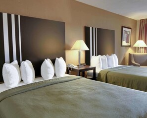 A hotel room with two beds, a desk, a chair, and two lamps. - Quality Inn & Suites Clarksville (Clarksville)