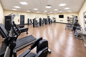 A gym with various exercise equipment, including treadmills, weight machines, and free weights. - Ramada by Wyndham Santee I-95 (Santee)