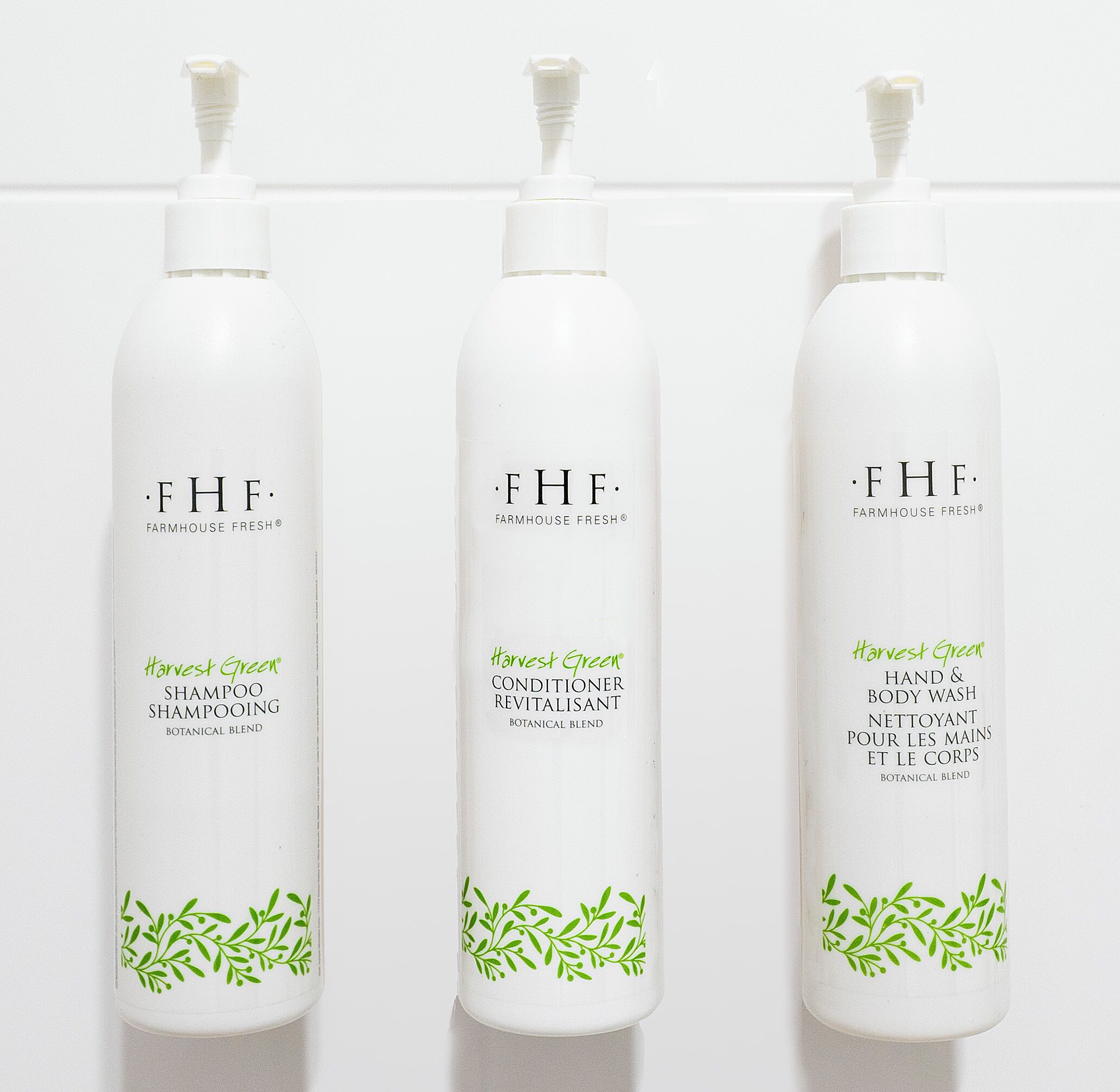 Three bottles of Farmhouse Fresh products with green leaf designs.