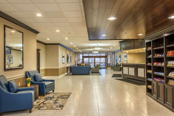 A lobby with seating, a reception desk, and a snack bar.