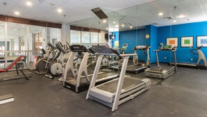 A gym with treadmills, ellipticals, and a red bench. - Best Western Plus Strongsville Cleveland (Strongsville)
