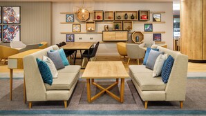 A modern living room with sofas, a coffee table, and a dining area. - Holiday Inn London - Heathrow M4,jct.4 by IHG (West Drayton)