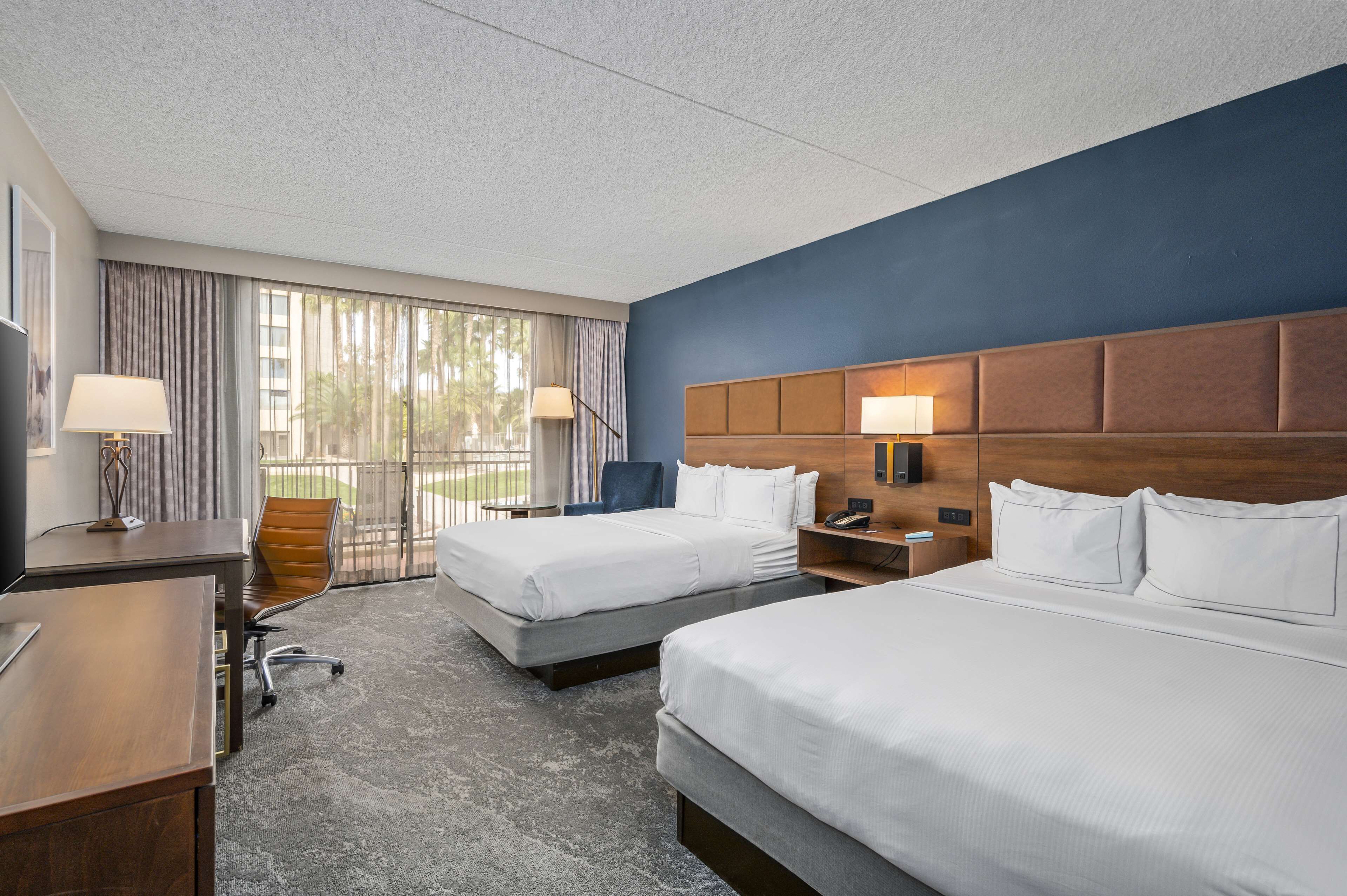 room, 2 queen beds, pool view | in-room safe, desk, blackout curtains, iron/ironing board