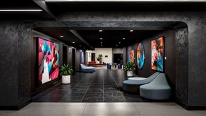 A modern lobby with a long corridor, seating areas, and large abstract paintings on the walls. - W Toronto (Toronto)