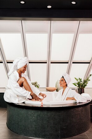 A spa setting with a reception area, a large window, and a plant. - W Toronto (Toronto)