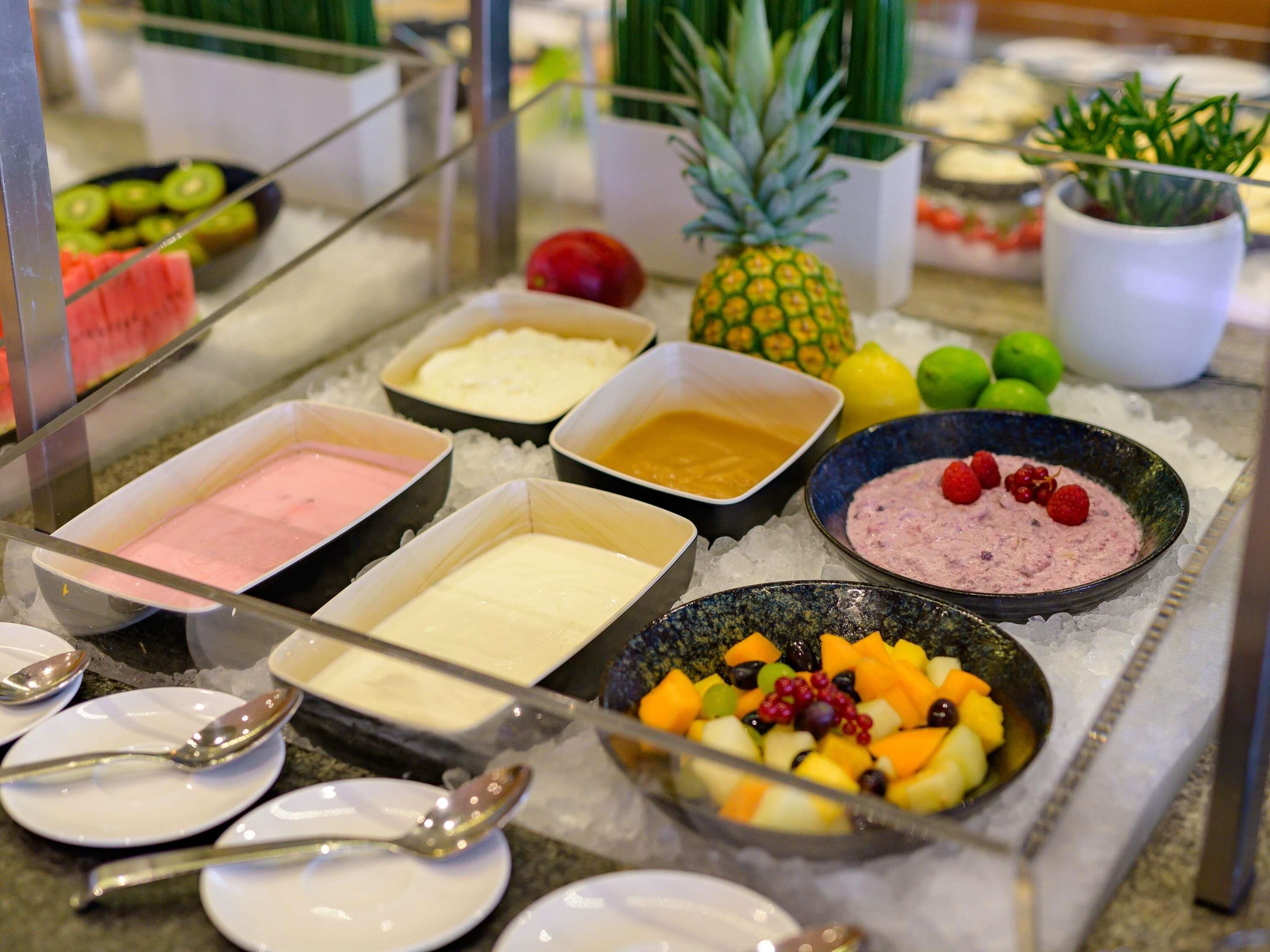 A buffet with various food items and beverages on ice.