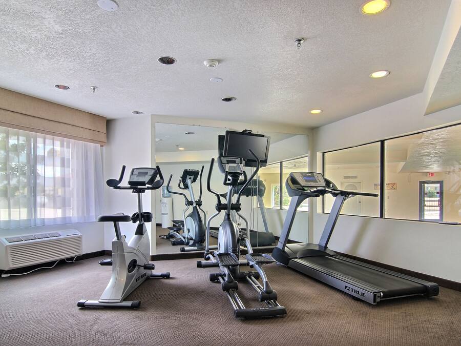 A gym with treadmills, elliptical machines, and stationary bikes.