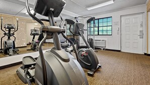 A gym with stationary bikes, elliptical machines, and a mirrored wall. - La Quinta Inn by Wyndham Costa Mesa / Newport Beach (Costa Mesa)