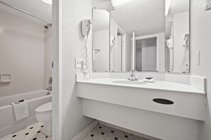 A modern bathroom with a white sink, mirror, and a shower area. - La Quinta Inn by Wyndham Costa Mesa / Newport Beach (Costa Mesa)