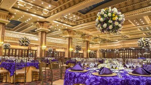 A banquet hall with tables set for a formal event, featuring ornate ceiling details and floral centerpieces. - Mercure Alameda Quito (Quito)