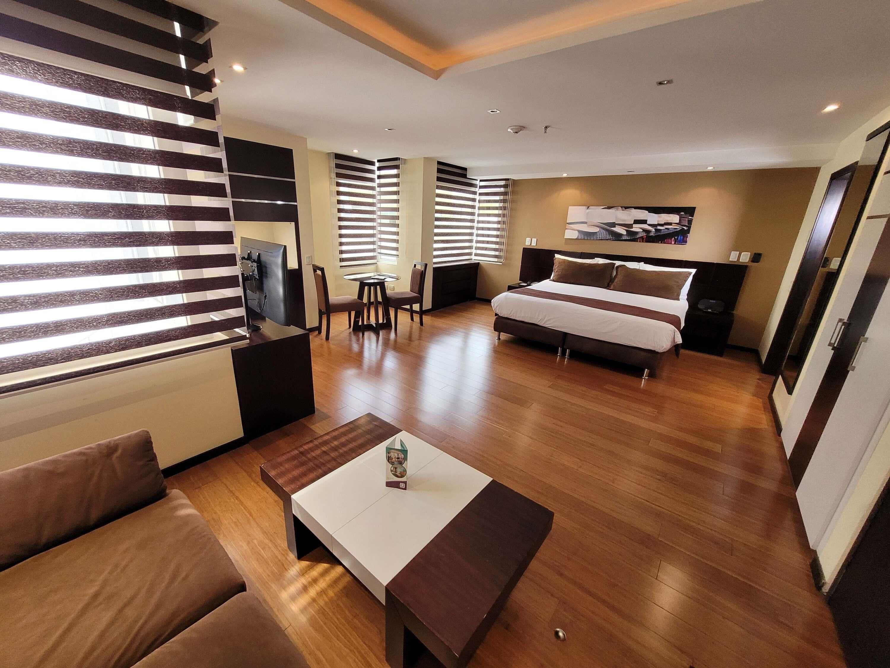 Deluxe Suite, 1 King Bed | Pillowtop beds, in-room safe, laptop workspace, blackout drapes