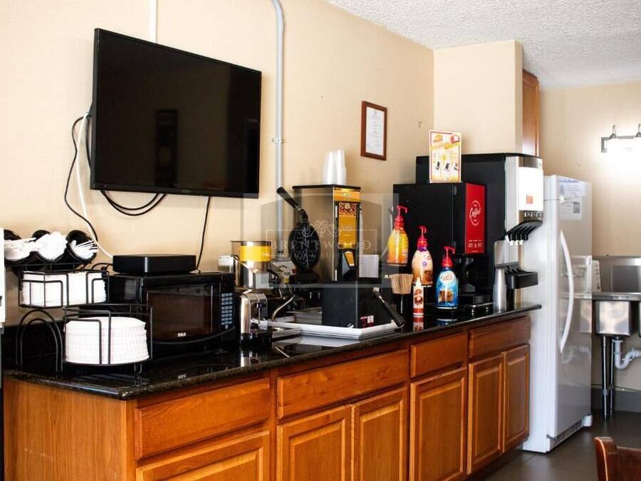 Una cuina americana amb microones, cafetera i nevera.