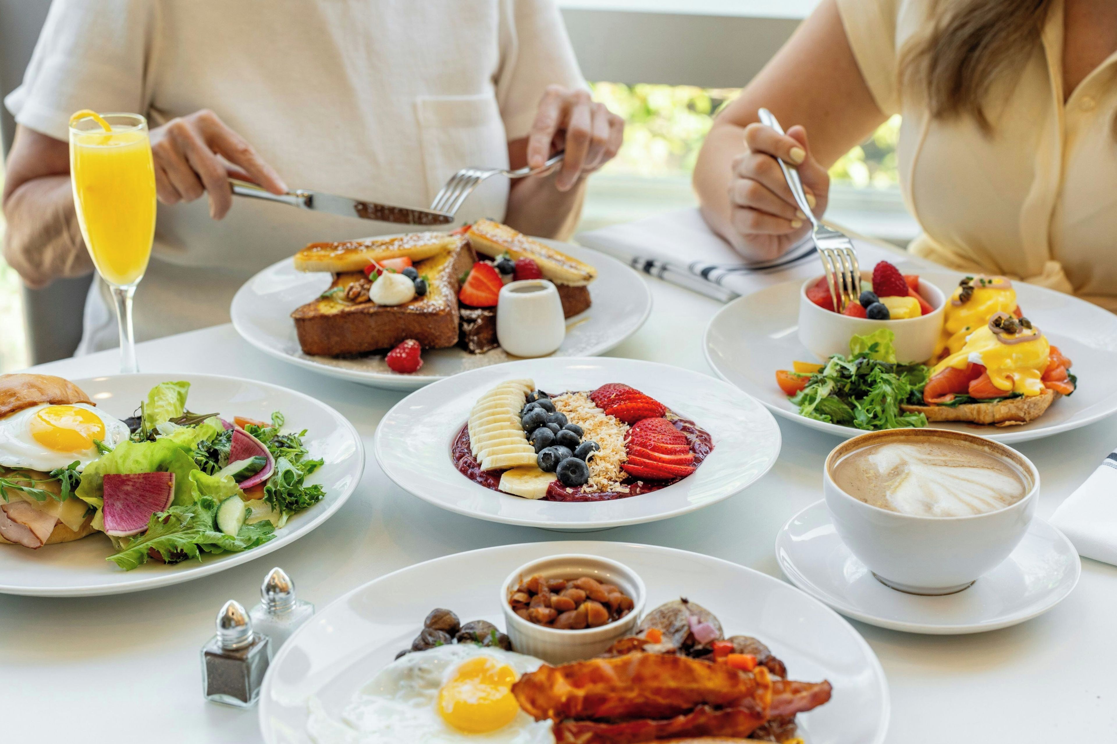 A breakfast setting with various dishes, including eggs, toast, and a coffee cup.