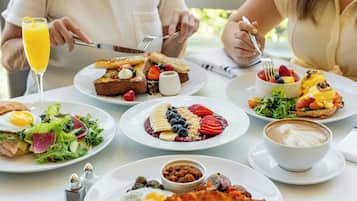 A breakfast setting with various dishes, including eggs, toast, and a coffee cup.