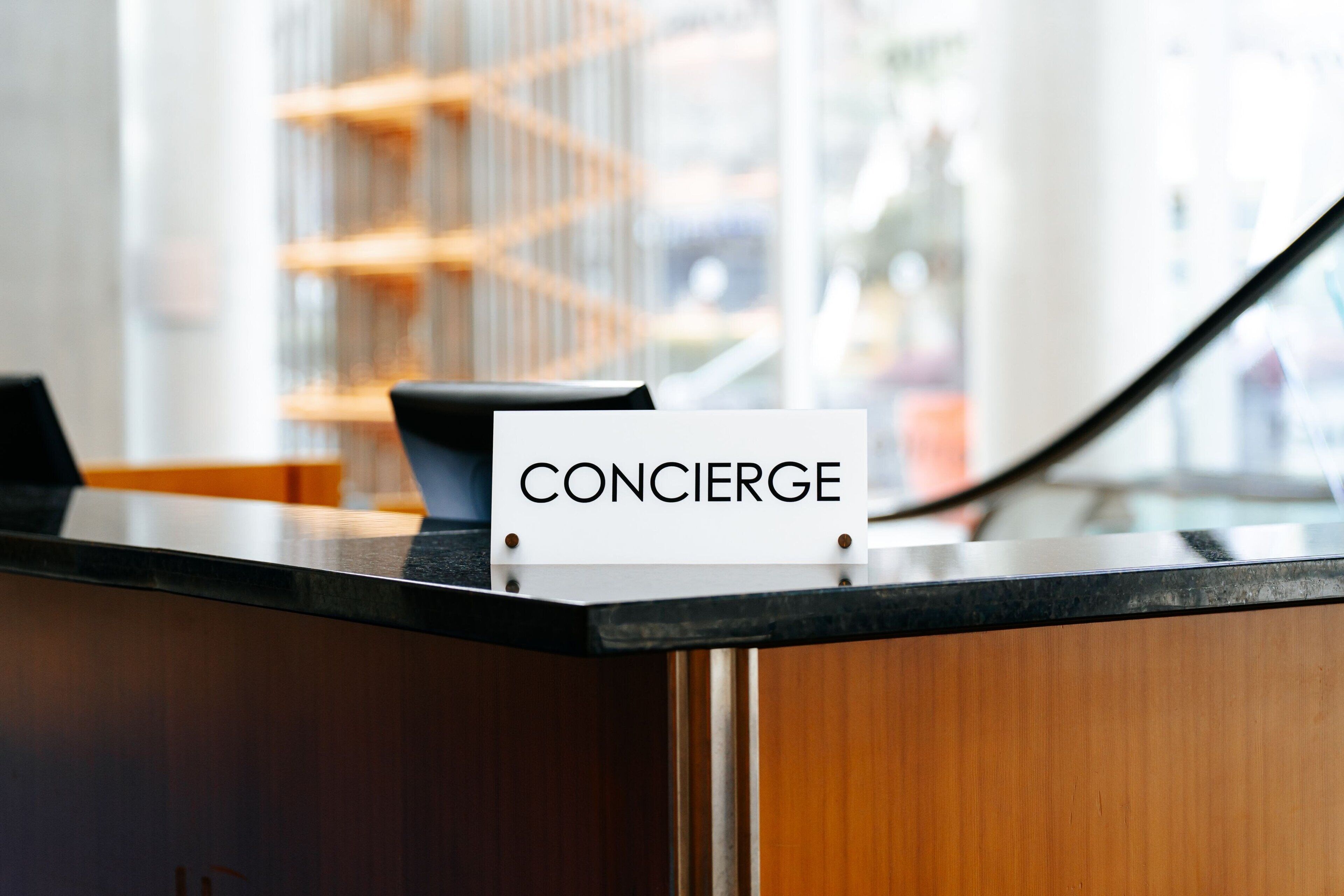 A reception desk with a sign that reads "CONCIERGE".