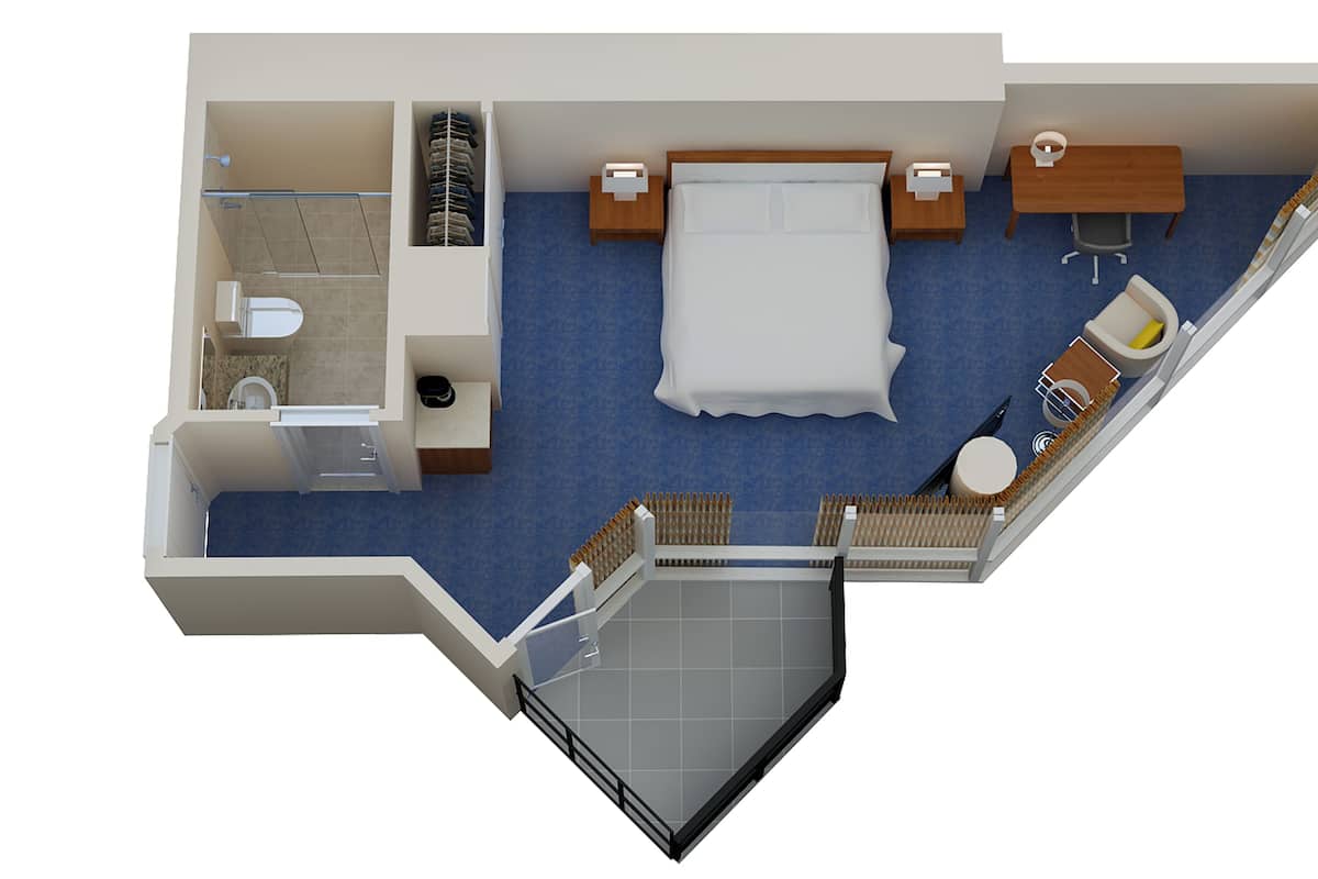 Distribución de una habitación de hotel con cama, escritorio, silla, pequeña mesa, sofá, baño y balcón.