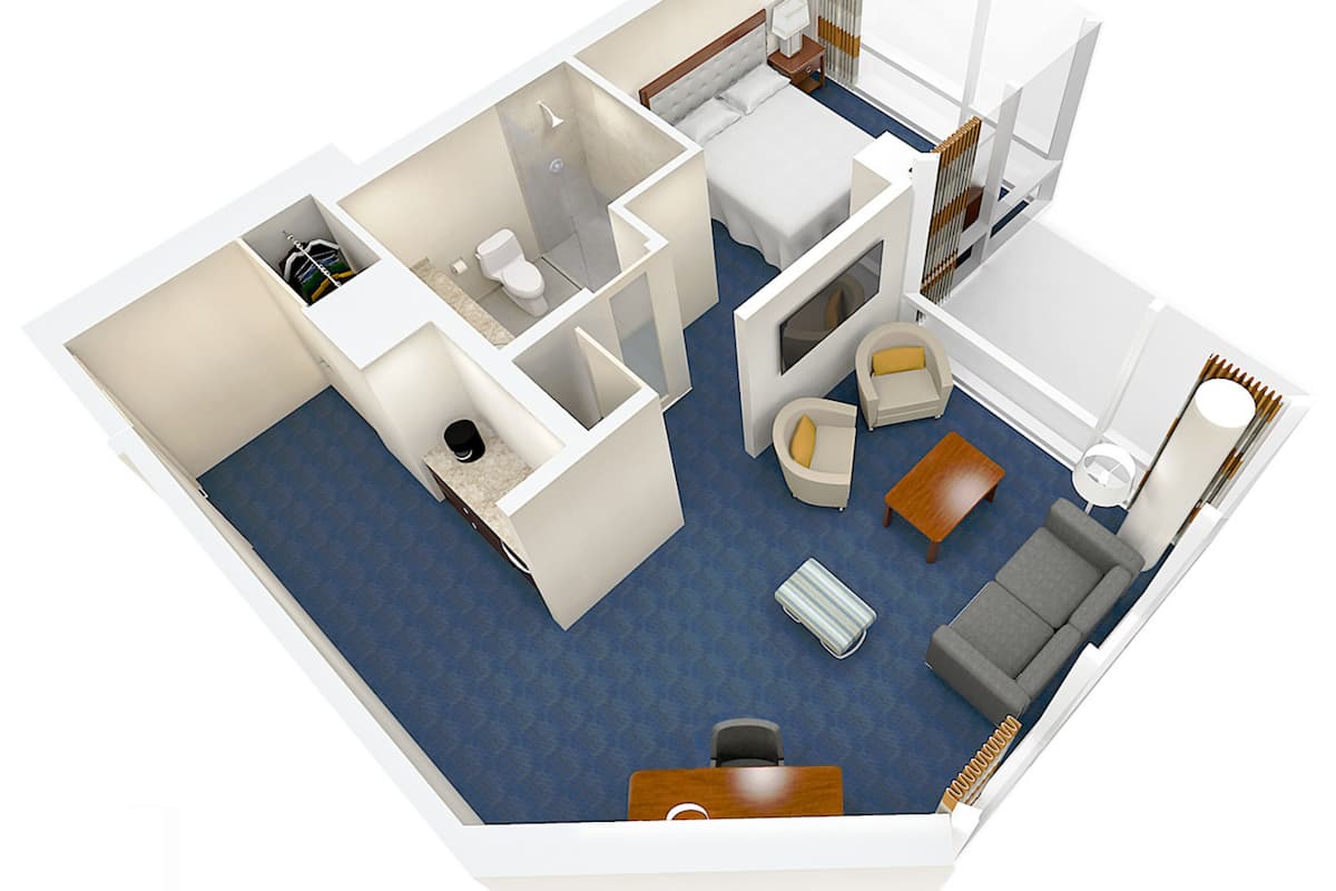 Plano en 3D de una habitación de hotel que incluye un baño, una zona de estar con un sofá y sillón, una pequeña mesa de comedor y una zona de dormitorio separada.