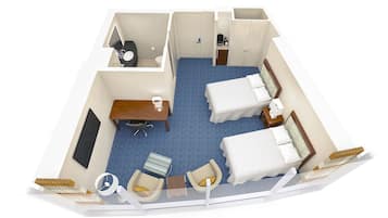 A hotel room with two beds, a desk, a chair, a small table, a sofa, and a TV.