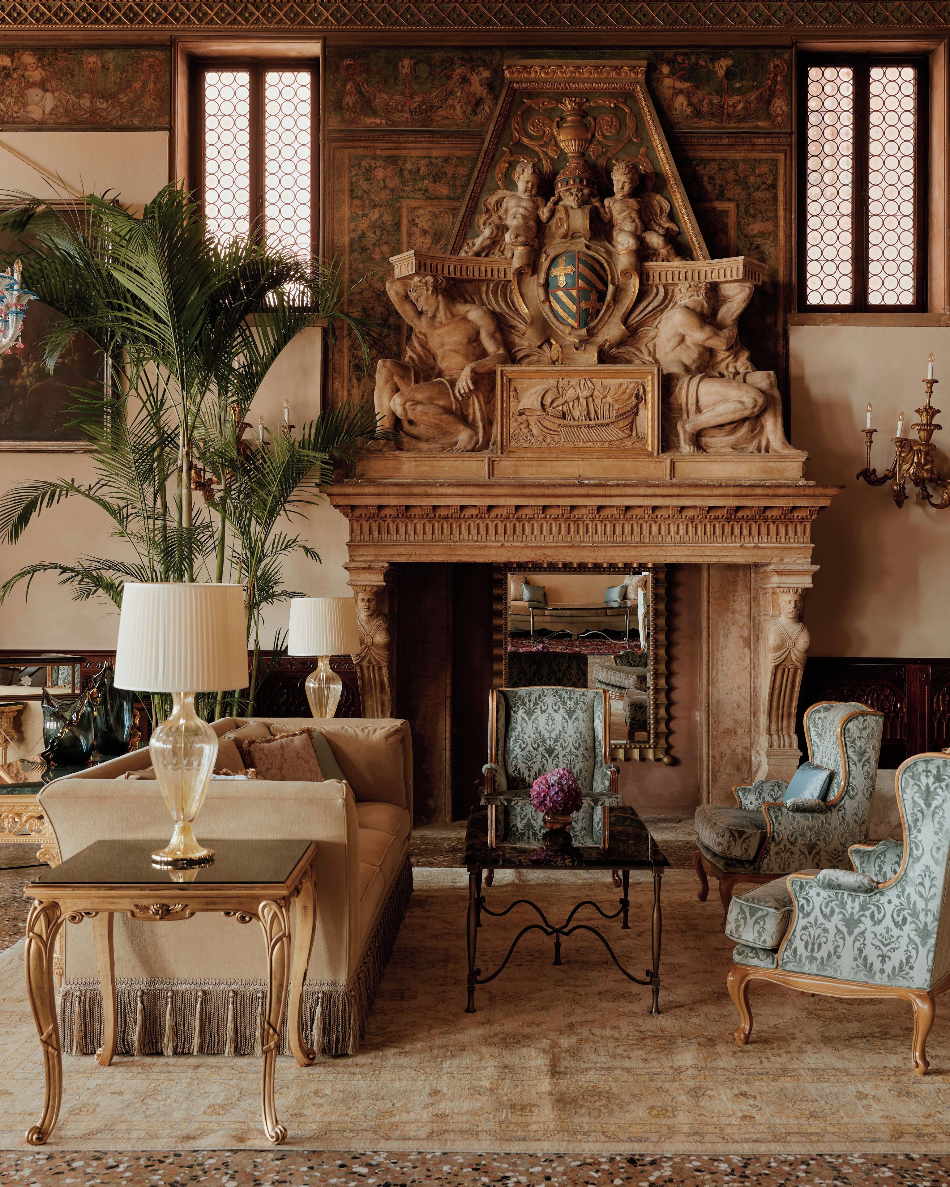A luxurious room with a fireplace, ornate wall decorations, and classic furniture.