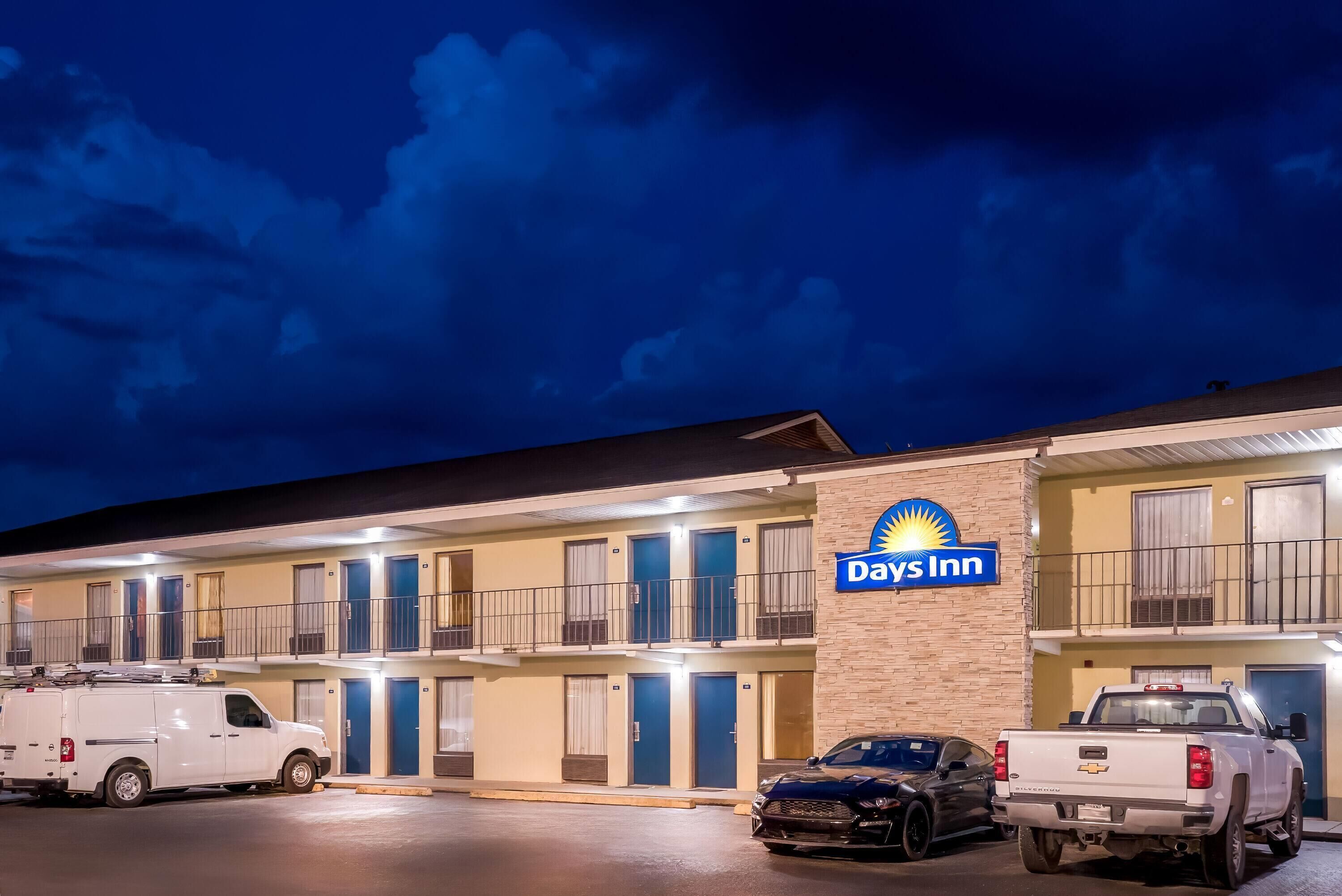 A Days Inn hotel with multiple rooms, a parking area, and a visible truck.