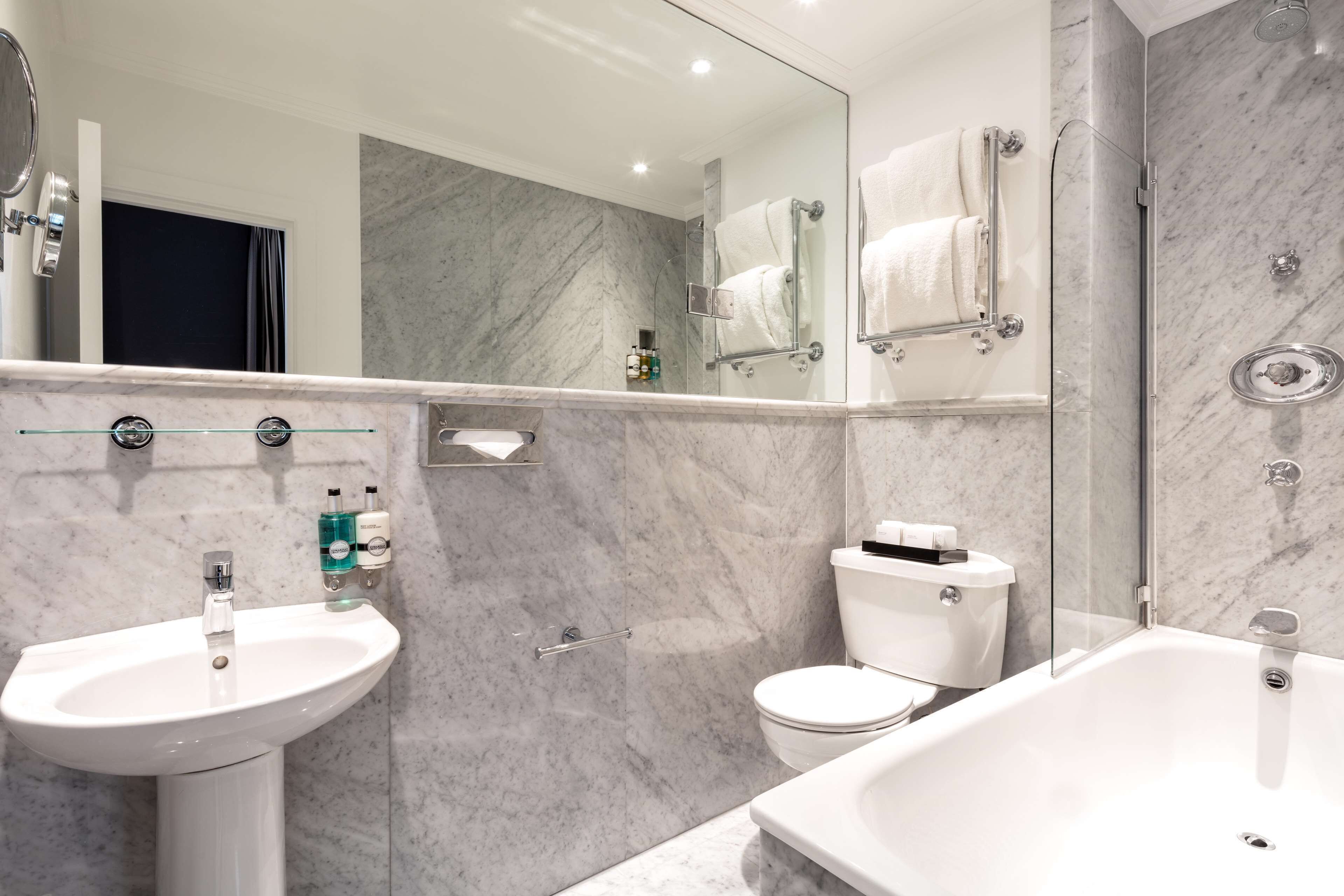 designer toiletries, hair dryer, towels