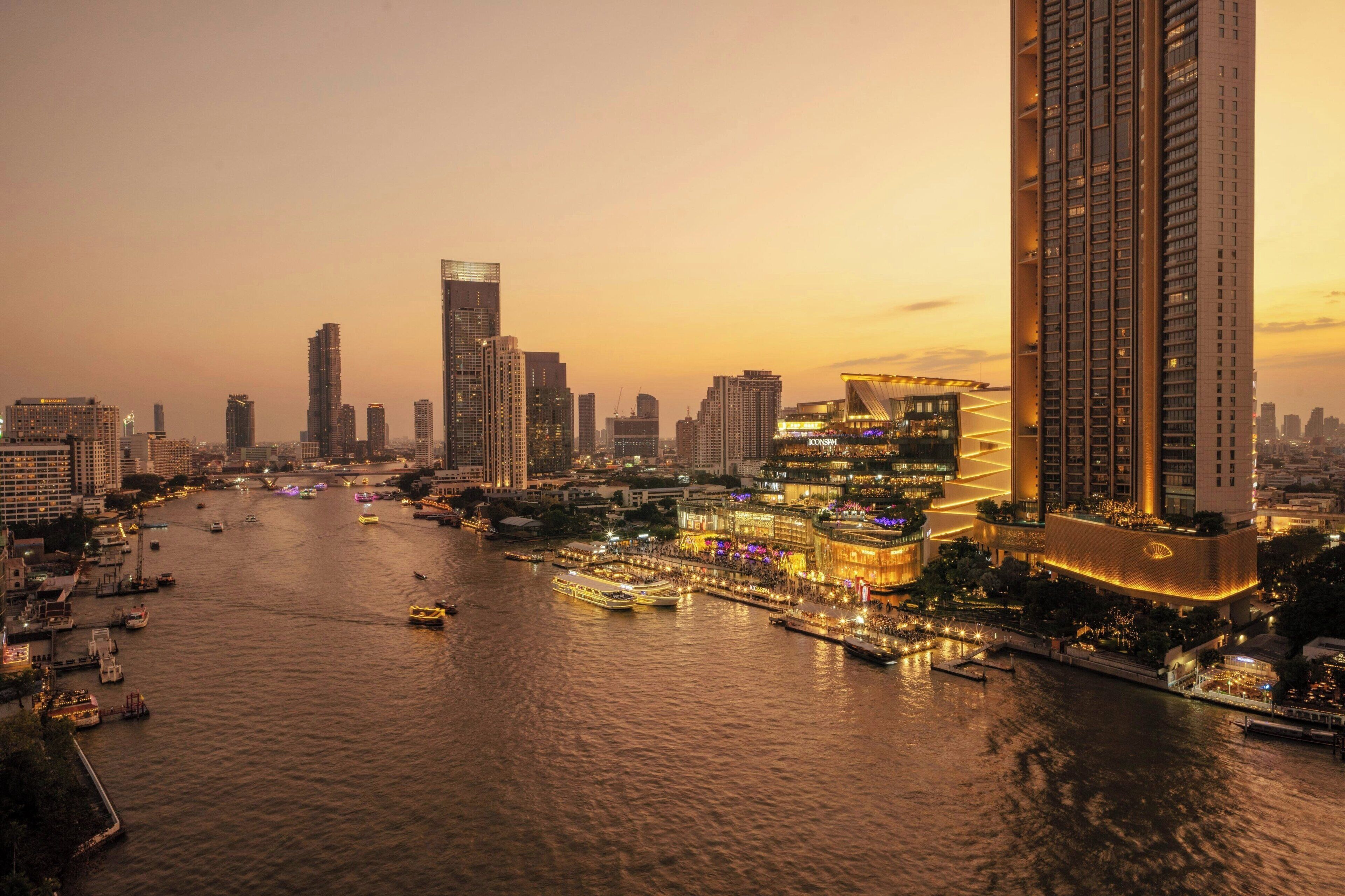A high-rise hotel with a waterfront view, multiple floors, and a modern architectural design.