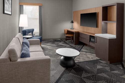 Suite, 1 King Bed | Living area | 32-inch LCD TV with cable channels, TV