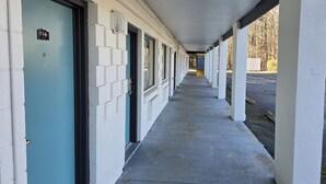 A corridor with doors numbered 116 and 117, leading to rooms. - Sunrise Inn By OYO Newport News US-60 (Newport News)