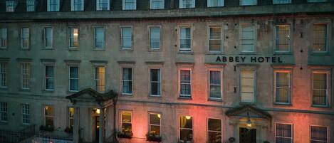 A historic building with the sign "Abbey Hotel" on the facade.