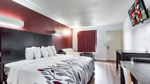 A hotel room with a bed, a desk, and a TV. - Red Roof Inn Monteagle - I-24 (Monteagle)