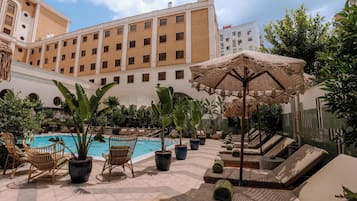 Outdoor pool, open 10:00 AM to 8:00 PM, pool umbrellas, pool loungers