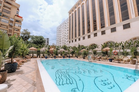 Outdoor pool, open 10:00 AM to 9:00 PM, pool umbrellas, sun loungers. Only YOU Hotel Sevilla