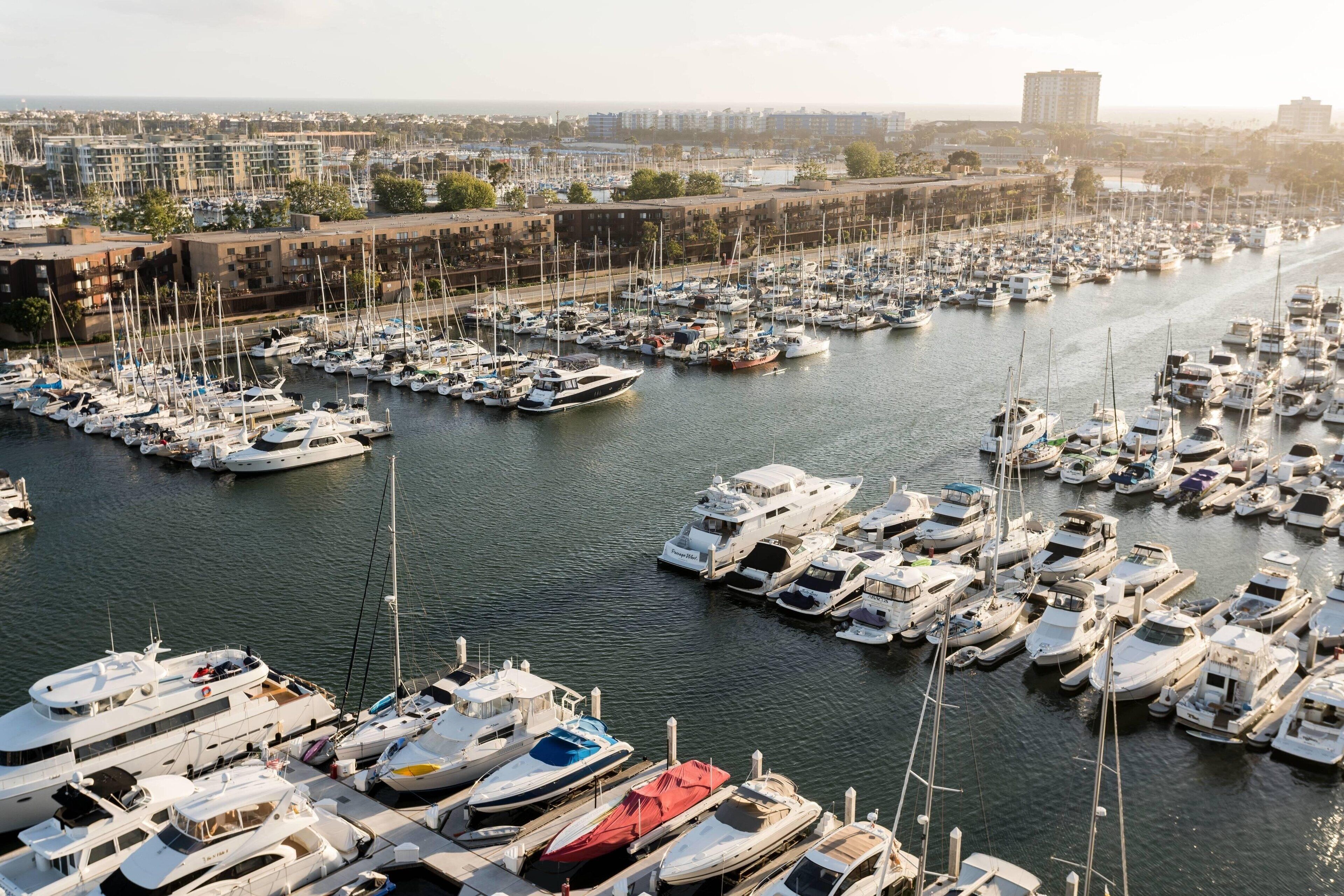 A marina filled with various boats docked in a harbor.