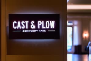 A sign with the text "CAST & PLOW COMMUNITY MADE".