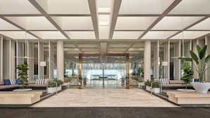 A spacious lobby with a high ceiling, large windows, and a central seating area. - Sheraton Grand Mirage Resort, Gold Coast (Main Beach)