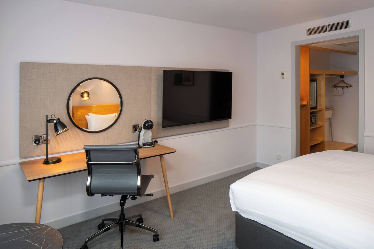 Desk, laptop workspace, blackout drapes, iron/ironing board