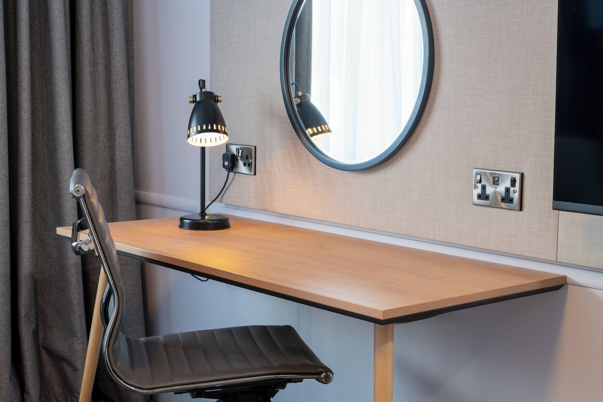 Desk, laptop workspace, blackout drapes, iron/ironing board
